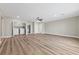 Spacious living area with stylish wood flooring, ceiling fan, and convenient washer/dryer setup at 321 Oil Lantern Ln, Las Vegas, NV 89145