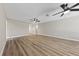 Open-concept living room featuring wood-look floors and multiple ceiling fans at 321 Oil Lantern Ln, Las Vegas, NV 89145