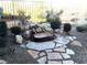Backyard with rock water feature, desert landscaping and wrought iron fence at 35 Emerald Dunes Cir, Henderson, NV 89052