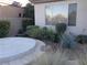 Landscaped backyard featuring a concrete patio and varied plant life for a relaxing outdoor space at 35 Emerald Dunes Cir, Henderson, NV 89052