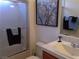 Well-lit bathroom featuring shower, decorative painting, and towel racks, providing a comfortable experience at 35 Emerald Dunes Cir, Henderson, NV 89052
