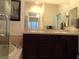 Bright bathroom featuring dual sinks, vanity, soaking tub, and tile at 35 Emerald Dunes Cir, Henderson, NV 89052