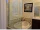 A soaking tub sits beneath plantation shutters in this home's bathroom at 35 Emerald Dunes Cir, Henderson, NV 89052