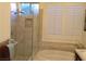 A shower and soaking tub combo highlighted by plantation shutters in this bathroom at 35 Emerald Dunes Cir, Henderson, NV 89052