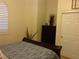 Bedroom featuring patterned comforter, bedside plants, and closet at 35 Emerald Dunes Cir, Henderson, NV 89052