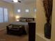 Spacious bedroom features a seating area, comfortable king bed and many windows at 35 Emerald Dunes Cir, Henderson, NV 89052