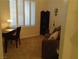 Cozy bedroom with a work desk, comfortable sofa, and plantation shutters for privacy and light control at 35 Emerald Dunes Cir, Henderson, NV 89052