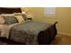 Comfortable bedroom featuring a floral patterned comforter and shuttered windows at 35 Emerald Dunes Cir, Henderson, NV 89052