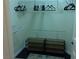 A closet is fitted with two metal racks and dark wood shelving for storage at 35 Emerald Dunes Cir, Henderson, NV 89052