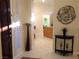 Bright entryway with tile flooring, shuttered sidelight and views to the dining and laundry areas at 35 Emerald Dunes Cir, Henderson, NV 89052