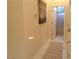 Hallway view leading to bathroom features neutral walls, tile floors, and an inviting ambiance at 35 Emerald Dunes Cir, Henderson, NV 89052