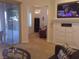 Open concept living room features neutral carpet, fireplace with mantle, and outdoor access at 35 Emerald Dunes Cir, Henderson, NV 89052