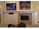 Stylish living room features a modern entertainment center with mounted TV and artwork above the fireplace at 35 Emerald Dunes Cir, Henderson, NV 89052