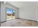 Bright bedroom showcasing tile flooring and a sliding glass door to the yard at 3684 Hawaii Ave, Las Vegas, NV 89104