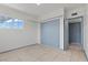 Bedroom features tile flooring, a closet, and bright window at 3684 Hawaii Ave, Las Vegas, NV 89104