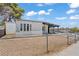 Charming single-story home featuring a covered porch and fenced yard on a sunny day at 3684 Hawaii Ave, Las Vegas, NV 89104