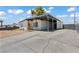 Single-story house with a large driveway, covered parking and sunny yellow front door at 3684 Hawaii Ave, Las Vegas, NV 89104
