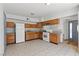 Spacious kitchen with wooden cabinets, tile flooring and granite countertops is ready for cooking at 3684 Hawaii Ave, Las Vegas, NV 89104