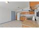 Bright, open kitchen with wooden cabinetry, gas range, granite counters and tile floor at 3684 Hawaii Ave, Las Vegas, NV 89104