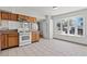 Bright kitchen features wood cabinets, tile flooring, gas range and large bay window for lots of light at 3684 Hawaii Ave, Las Vegas, NV 89104