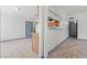 Open-concept living space featuring tiled floors and access to the kitchen, laundry, and hallway at 3684 Hawaii Ave, Las Vegas, NV 89104