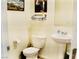 Efficient powder room with a pedestal sink, updated flooring, and modern fixtures at 3763 Sonrisa Vista Ave, Henderson, NV 89044
