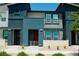 Stylish townhome with a modern facade, featuring clean lines, a red door, and well-maintained landscaping at 3763 Sonrisa Vista Ave, Henderson, NV 89044