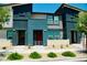 Charming townhouse with eye-catching blue accents and manicured landscaping, creating an appealing curb presence at 3763 Sonrisa Vista Ave, Henderson, NV 89044