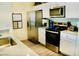 Modern kitchen with stainless steel appliances, white cabinets, and ample countertop space at 3763 Sonrisa Vista Ave, Henderson, NV 89044