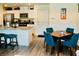 Bright kitchen and dining area features white cabinets, stainless steel appliances and seating at the bar at 3763 Sonrisa Vista Ave, Henderson, NV 89044