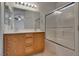 Bathroom boasts double sinks, a large mirror with modern lighting, and a shower-tub combo with glass doors at 3936 Pepper Thorn Ave # 3, North Las Vegas, NV 89081