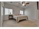 Bright bedroom with a neutral color scheme and comfortable layout features a ceiling fan and two windows at 3936 Pepper Thorn Ave # 3, North Las Vegas, NV 89081