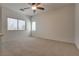 Bright, spacious bedroom features neutral carpeting, a ceiling fan, and two windows that provide natural light at 3936 Pepper Thorn Ave # 3, North Las Vegas, NV 89081