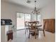 Dining area with backyard access and a chandelier for overhead lighting at 3936 Pepper Thorn Ave # 3, North Las Vegas, NV 89081