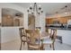 Charming dining area with a round table, wood chairs, and view of the kitchen bar at 3936 Pepper Thorn Ave # 3, North Las Vegas, NV 89081