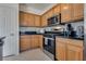 Kitchen area with wooden cabinets and stainless steel appliances at 3936 Pepper Thorn Ave # 3, North Las Vegas, NV 89081