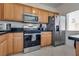 Kitchen features granite counters, stainless appliances, and wooden cabinets at 3936 Pepper Thorn Ave # 3, North Las Vegas, NV 89081