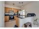 Kitchen with wooden cabinets, granite countertops, and stainless steel appliances at 3936 Pepper Thorn Ave # 3, North Las Vegas, NV 89081