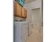 Bright laundry room with washer, dryer and cabinets for organizing cleaning supplies at 3936 Pepper Thorn Ave # 3, North Las Vegas, NV 89081
