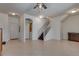 Open-concept living room featuring tile flooring and a staircase with white wood trim at 3936 Pepper Thorn Ave # 3, North Las Vegas, NV 89081