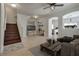 Inviting living room with wood staircase, neutral tones, and modern decor provides a comfortable space at 3936 Pepper Thorn Ave # 3, North Las Vegas, NV 89081