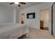 Comfortable main bedroom features a wall mounted tv and easy access to en suite bathroom and walk-in closet at 3936 Pepper Thorn Ave # 3, North Las Vegas, NV 89081