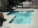 Hot tub with clear water, pool rules posted, and an access gate at 4050 Pacific Harbors Dr # 214, Las Vegas, NV 89121