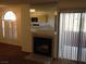Living room featuring a fireplace, sliding door, and view into the kitchen at 4050 Pacific Harbors Dr # 214, Las Vegas, NV 89121