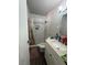 Bathroom featuring tiled shower, wood floors, neutral paint and vanity with solid-surface counters at 4503 Springdale Ave, Las Vegas, NV 89121