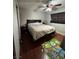 Bedroom featuring wood floors, a large bed, side table, and a ceiling fan at 4503 Springdale Ave, Las Vegas, NV 89121