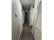 Long hallway featuring wood-look flooring and neutral paint, connecting various rooms in the home at 4503 Springdale Ave, Las Vegas, NV 89121