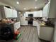 Functional kitchen with white cabinets, appliances, ample counter space, and wood-look flooring at 4503 Springdale Ave, Las Vegas, NV 89121