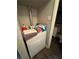 Compact laundry area featuring a washer, dryer, and nearby bathroom at 4503 Springdale Ave, Las Vegas, NV 89121