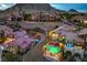 Beautiful aerial view of upscale community with luxury homes, mature landscaping, and stunning mountain backdrop at 47 Strada Principale, Henderson, NV 89011